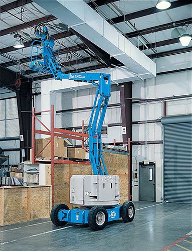 Worker fixing ceiling on a scissor lift